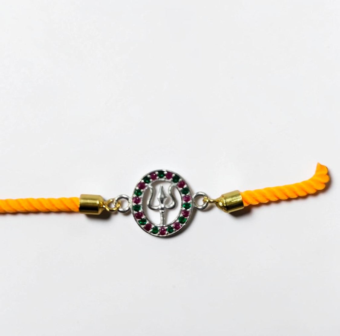 Silver Trishul Rakhi with Ruby & Emerald Stones
