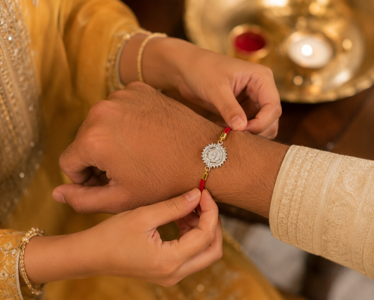 Red Braided Rakhi with Sunburst Medallion